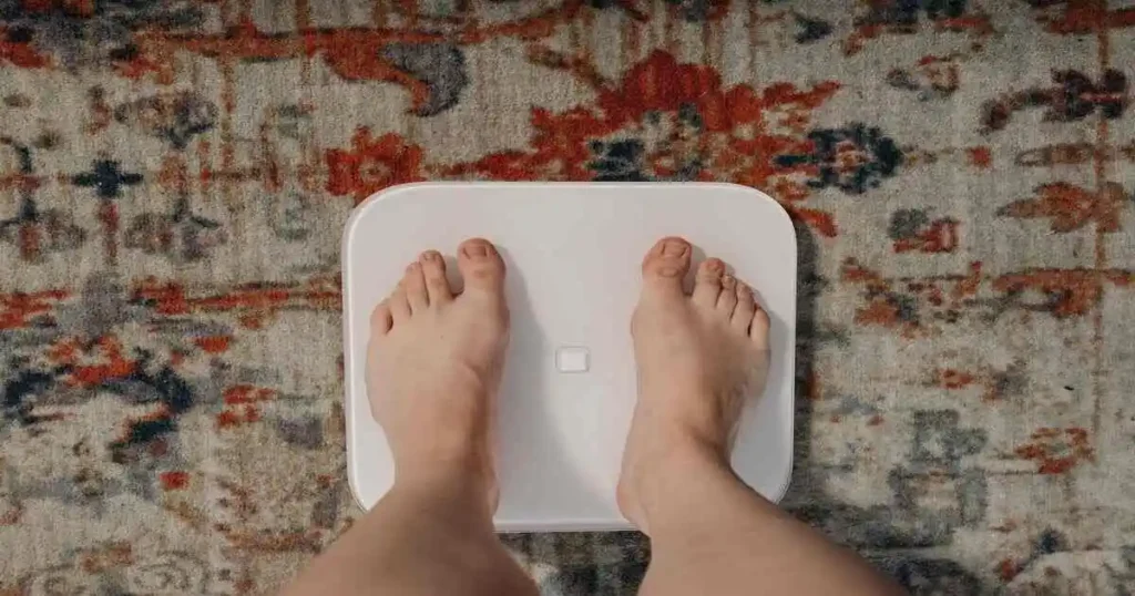 person checkingthe weight for good health goal