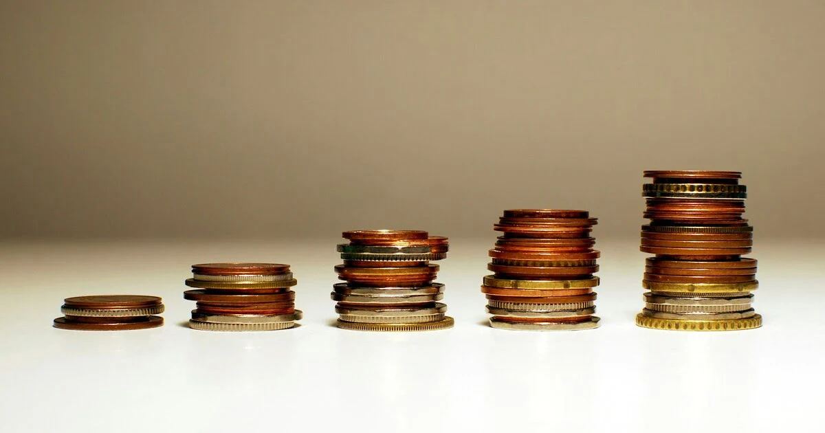 Stacked coins showing financial growth from simple interest vs compound interest